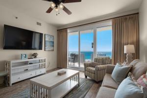 a living room with a couch and a tv and a table at Ariel Dunes II 1807- High Tide in Destin