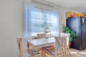 a kitchen with a table and chairs and a refrigerator at Gulf Crest #7 in Destin