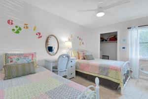 a bedroom with two beds and a mirror at Gulf Crest #7 in Destin +27 photos