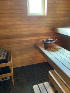 a wooden room with a bucket on a wooden table at Stava Mosters in Mariehamn +27 photos