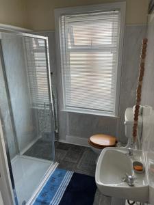 a bathroom with a shower and a toilet and a sink at Victoria House - Self Catering Quiet Guesthouse - Adult Singles and Couples Only in Blackpool