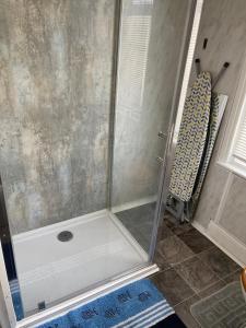 a shower with a glass door in a bathroom at Victoria House - Self Catering Quiet Guesthouse - Adult Singles and Couples Only in Blackpool