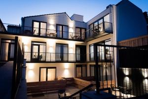 a building with balconies and lights on it at Hotel La Source Epen in Epen