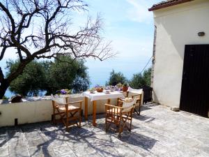 a table and chairs sitting on a patio at Tsoupis Farm House in Agní