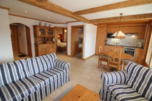 a living room with two couches and a kitchen at Gai Torrent 103 in Bagnes