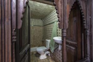 a small bathroom with a toilet and a sink at Dar Chourouk in Fez