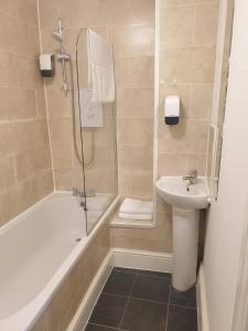 a bathroom with a shower and a sink and a tub at Park View in Hull +33 photos