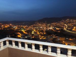 a view of a city at night from a balcony at Authentic boutique in Wadi Musa