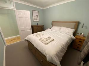 a bedroom with a bed with two towels on it at Spacious and bright 1 - bedroom rental unit in Ilkley