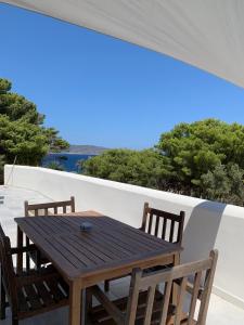 a wooden table and two chairs on a balcony at Dimora delle Tonnare in Favignana