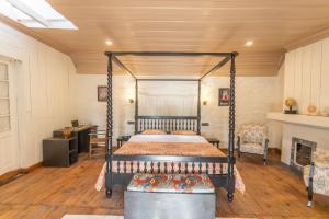 a bedroom with a canopy bed and a fireplace at Seclude Shimla, Taraview in Shimla