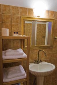 a bathroom with a sink and a mirror at Villa Kastanodasos in Emporio