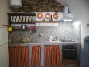 a kitchen with a sink and a stove at casa del vicolo verde in Pontremoli