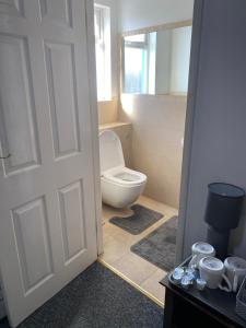 a bathroom with a toilet and a door open at The Woodfield Hotel in Blackpool