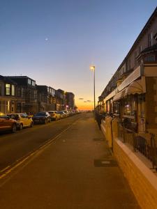 a street with cars parked on the side of the road at The Woodfield Hotel , Indoor Heated swimming pool, Spacious lounge and Bar in Blackpool