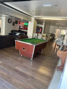 a living room with a pool table in it at The Woodfield Hotel in Blackpool