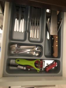 a plastic container with utensils in a drawer at Ferienwohnung Eberhard Altes Winzerhaus in Bullay
