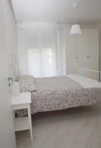een witte slaapkamer met een bed en een wit bureau bij Villa Schiaffino Appartamento al Primo Piano in Deiva Marina