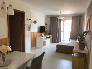 a living room with a couch and a table at Praia Castelhanos - ES in Anchieta