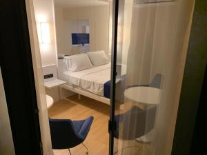 a bedroom with a bed and a table and a mirror at Luxury Studio with Ocean View in Batumi
