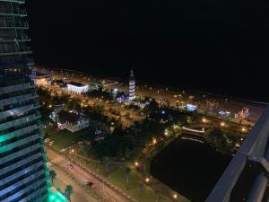 an aerial view of a city at night at Luxury Studio with Ocean View in Batumi