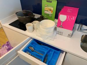 a drawer with cups and dishes in a kitchen at Luxury Studio with Ocean View in Batumi