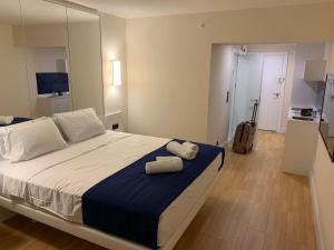 a bedroom with a large bed with two towels on it at Luxury Studio with Ocean View in Batumi