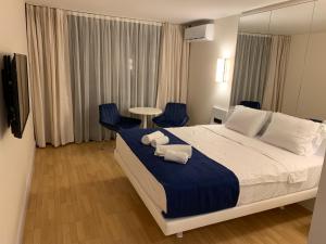 a hotel room with a bed with towels on it at Luxury Studio with Ocean View in Batumi