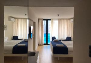 a bedroom with two beds and a large mirror at Luxury Studio with Ocean View in Batumi +18 photos