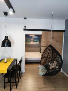 a room with a hammock and a bedroom with a bed at Stary rynek in Zawiercie