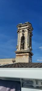 une tour d'horloge au sommet d'un bâtiment dans l'établissement B&B La Maddalena, à Sammichele di Bari