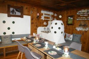 a dining room with a table and two chairs at Thalerhof in Roppen