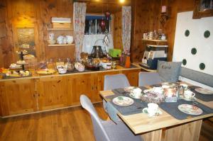 a kitchen with a table and chairs and a counter at Thalerhof in Roppen