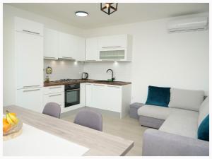 a kitchen and living room with a couch and a table at House Natalija in Podgreben +30 photos