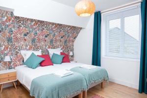 a bedroom with two beds and a wall mural at Gîtes de la Vesée in La Chapelle dʼArmentières +32 photos