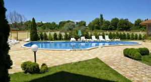 a large swimming pool with chairs in a yard at Александра Палас in Kranevo +13 photos