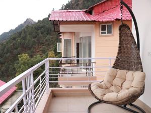 a chair sitting on the balcony of a house at amravati resort in Solan