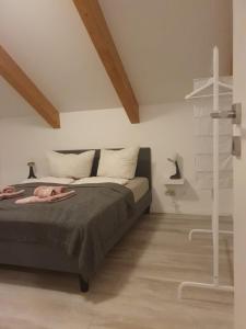 a bedroom with a bed and a cross on the wall at Ferienhaus am Burggraben in Stendal