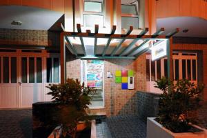 a restaurant with plants in front of a building at Atlantic Sal Hostel in Santa Maria
