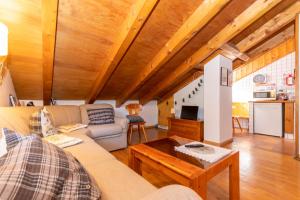a living room with a couch and a table at Dimora Catitti in Mazzin