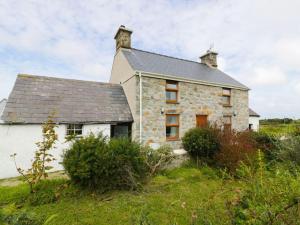 an old stone house on a grassy field at Ty Rhos, Farm Stay, sleeps 4, Rhoshirwaun 2 miles from Aberdaron in Aberdaron
