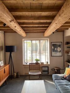 a living room with a couch and a window at La Blanchisserie in Maussane-les-Alpilles