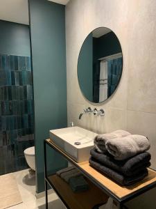 a bathroom with a sink and a mirror at La Blanchisserie in Maussane-les-Alpilles