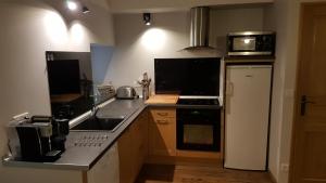 a kitchen with a sink and a microwave at Maison de montagne in Latour-de-Carol +6 photos