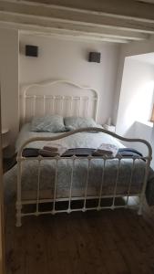 a bed in a room with a white frame at Maison de montagne in Latour-de-Carol