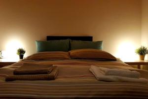 a large bed with some pillows on top of it at A casa di Rudy in Biancavilla