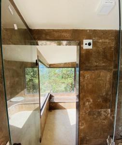 a bathroom with a shower and a glass door at Maravilhosa Casa Buzios in Búzios