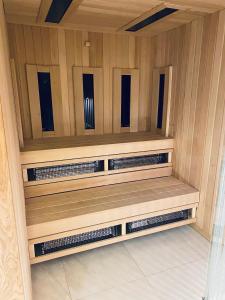 a sauna with wood paneling and wooden shelves at Apartament Błękitna Zatoka z Sauną in Puck