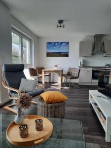 a living room with a couch and a table at Ostseeabenteuer in Scharbeutz