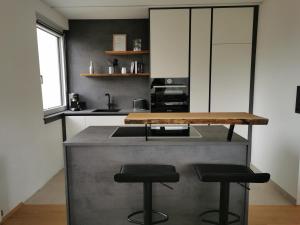 a kitchen with a counter top and two stools at Am Grimming 14 in Tauplitz